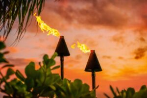 tiki torches at luau during sunset